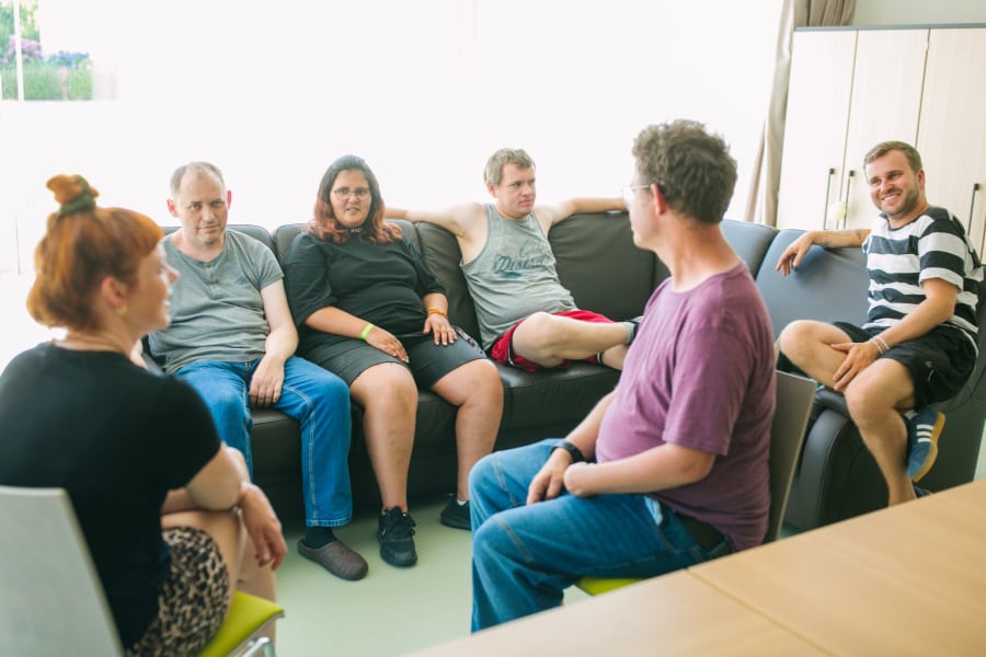 Sechs Personen chillen auf dem Sofa